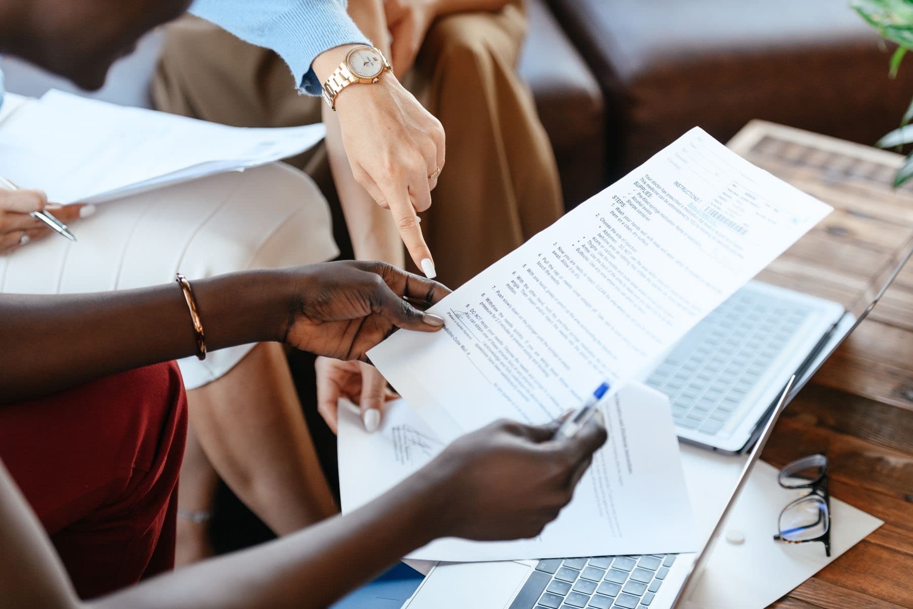 Colleagues reviewing printed documents together at a table