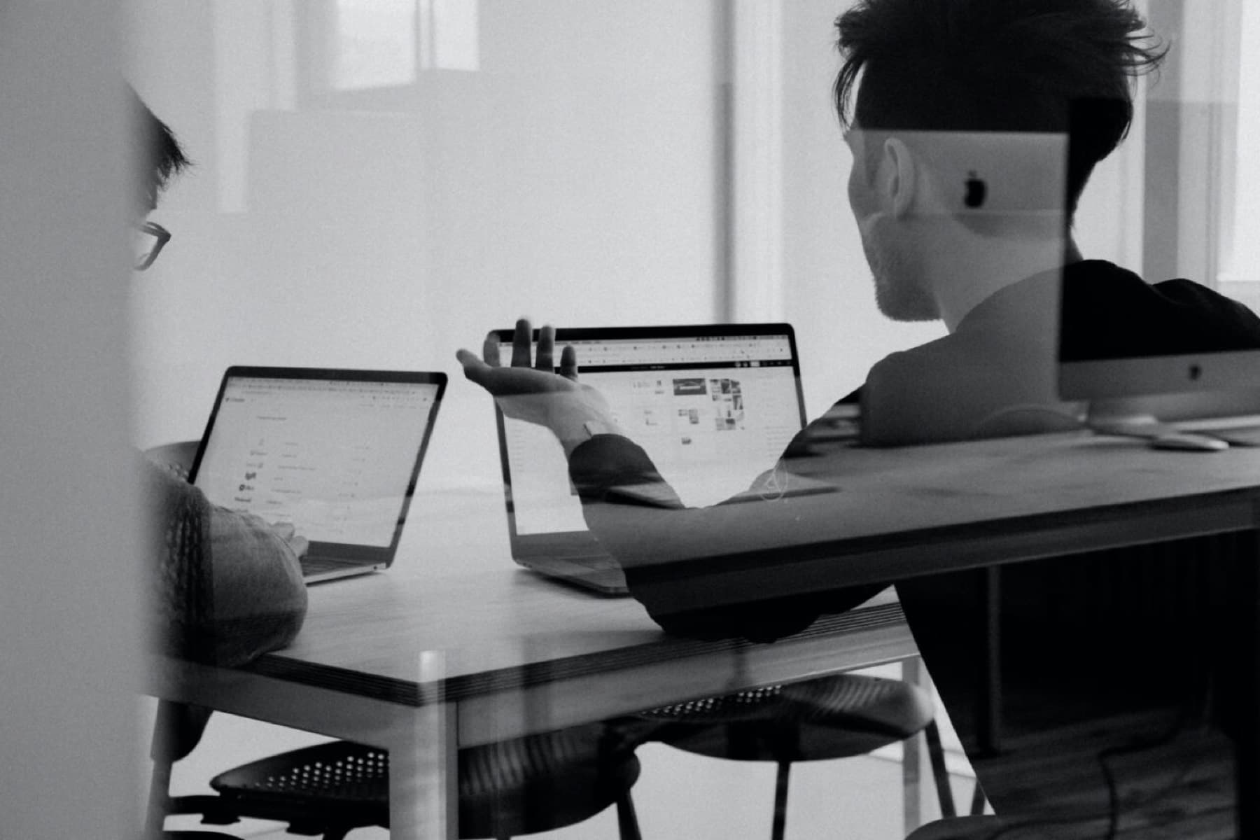 Two InspireX consultants working together at a shared desk